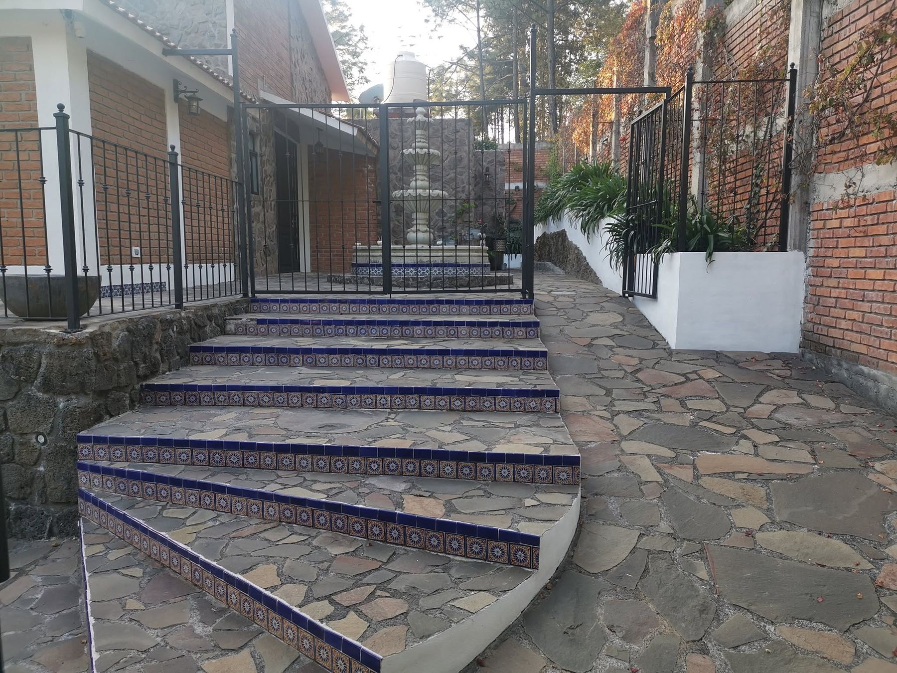 Escalinata de piedra con contrahuellas de talavera azul